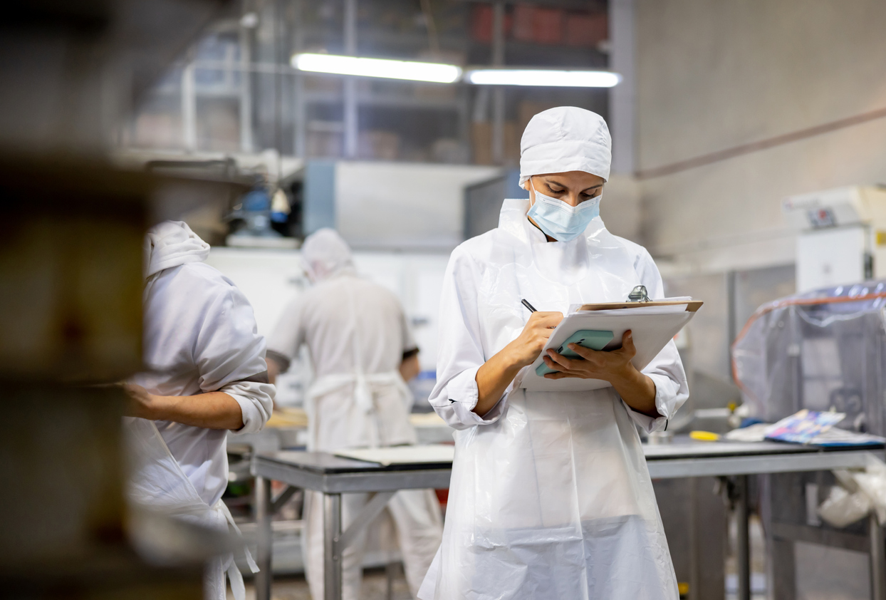 A woman ensures factory operations are adhering to the guidelines set forth by the Food Safety Modernization Act (FSMA).