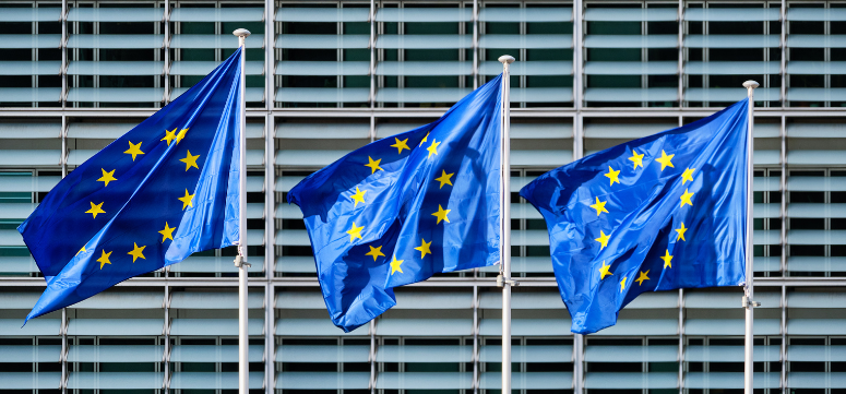 Three EU flags representing European Parliament which passed EU Regulation 1223/2009 for cosmetics companies marketing products in the EU.