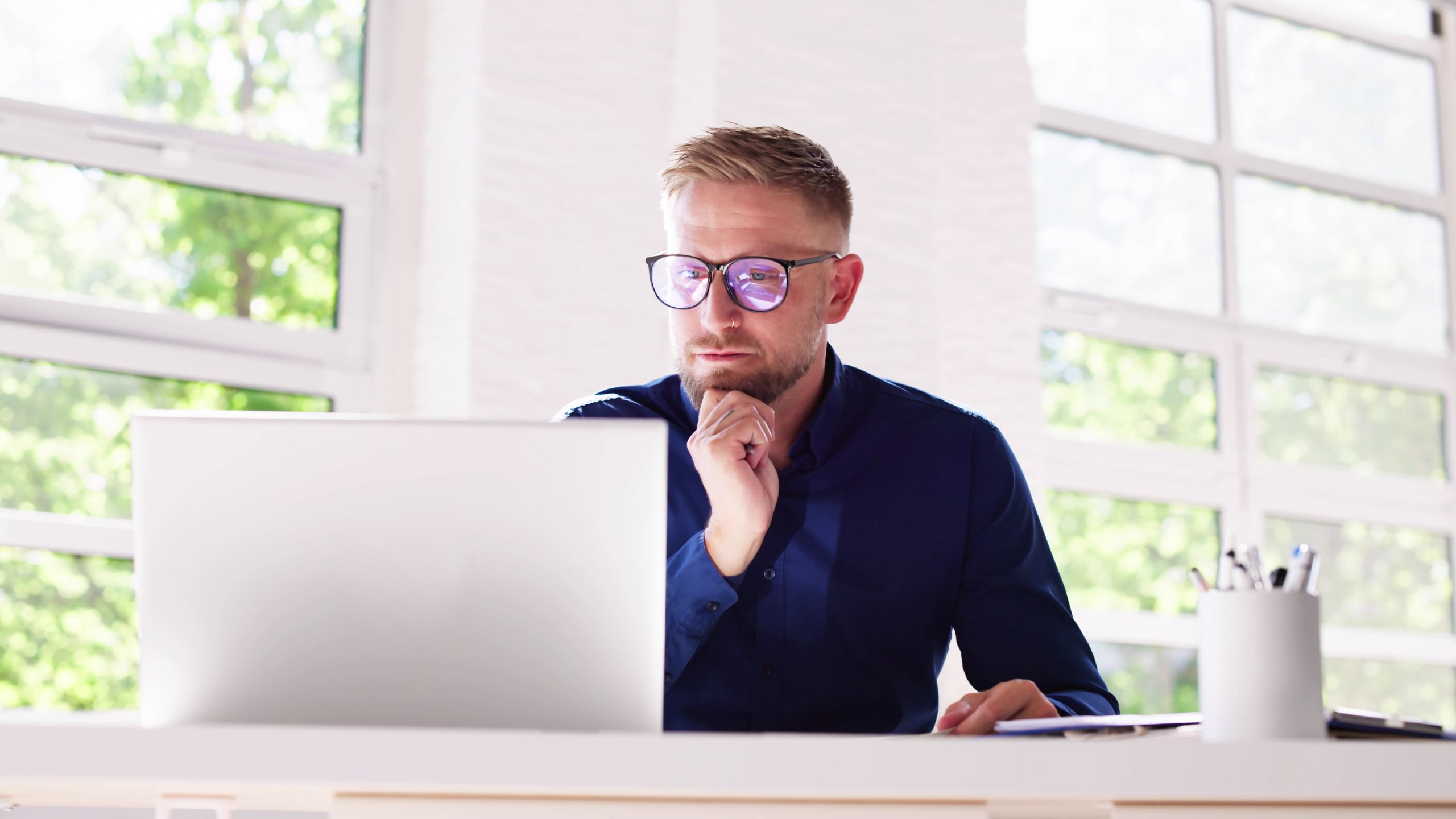 A man sits at his laptop as he reads how PCQI Certification is a misconception.