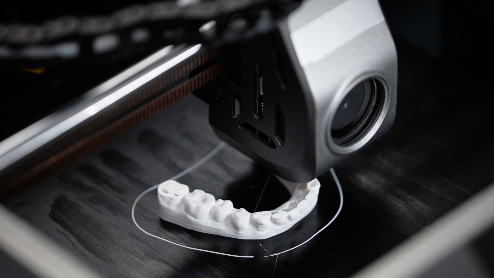 A 3d printer generates custom dental implants.