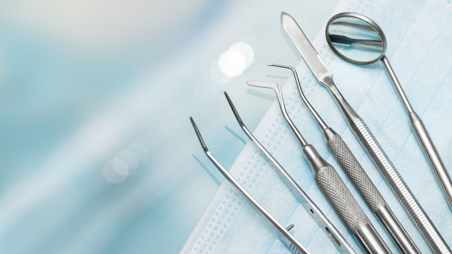 Dental Surgical Instruments are laid out on a clean and sanitary surface.