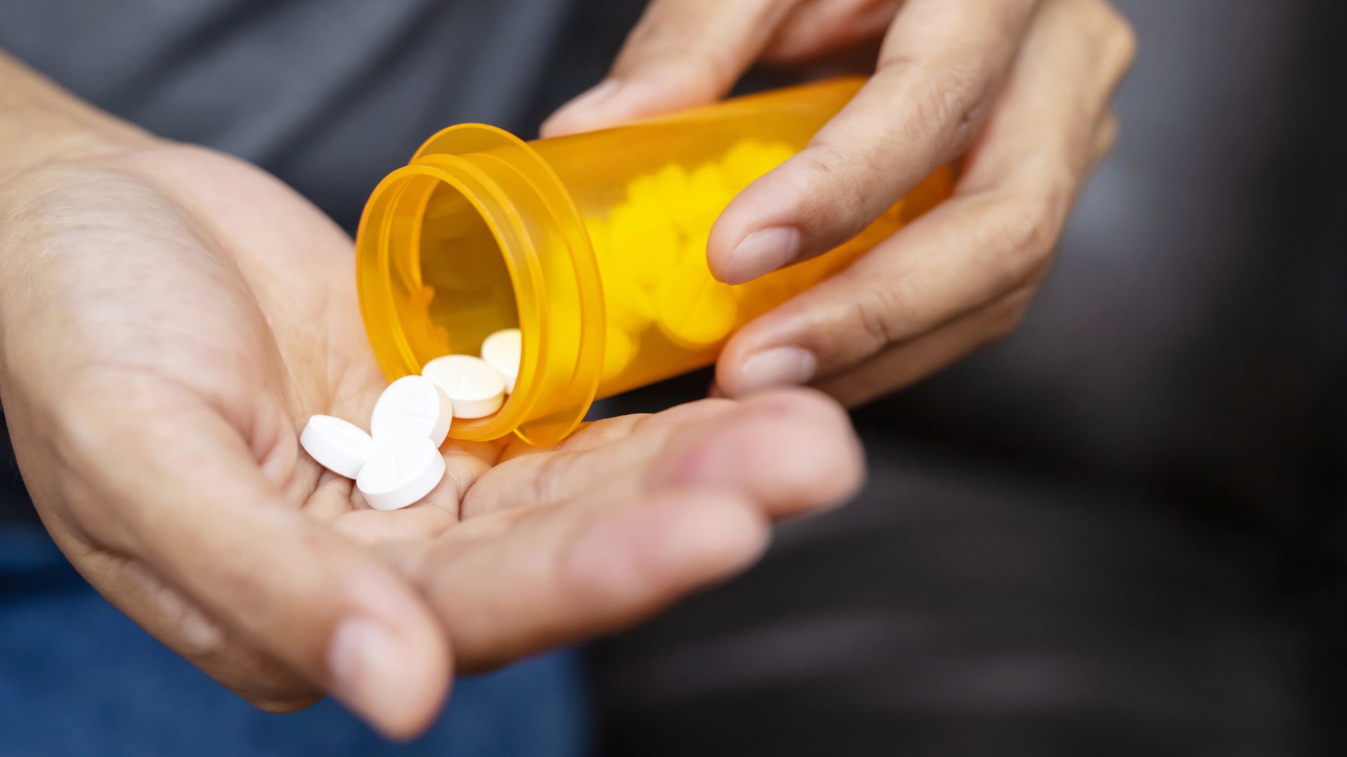 A man pours pills subject to FDA Drug Master Files (DMF) into his hand.