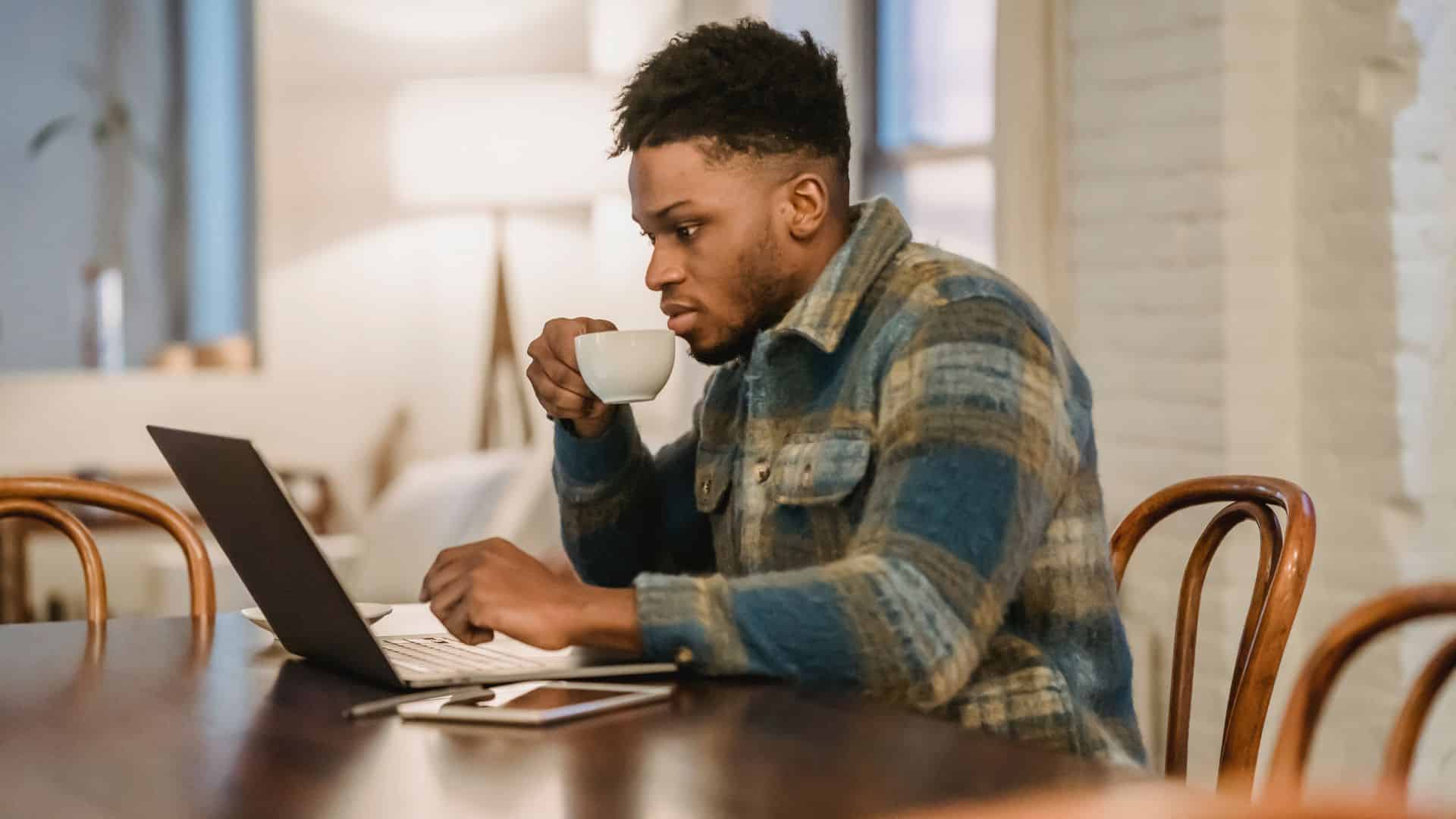 A young man on his laptop prepares for HACCP Certification by understanding its requirements.