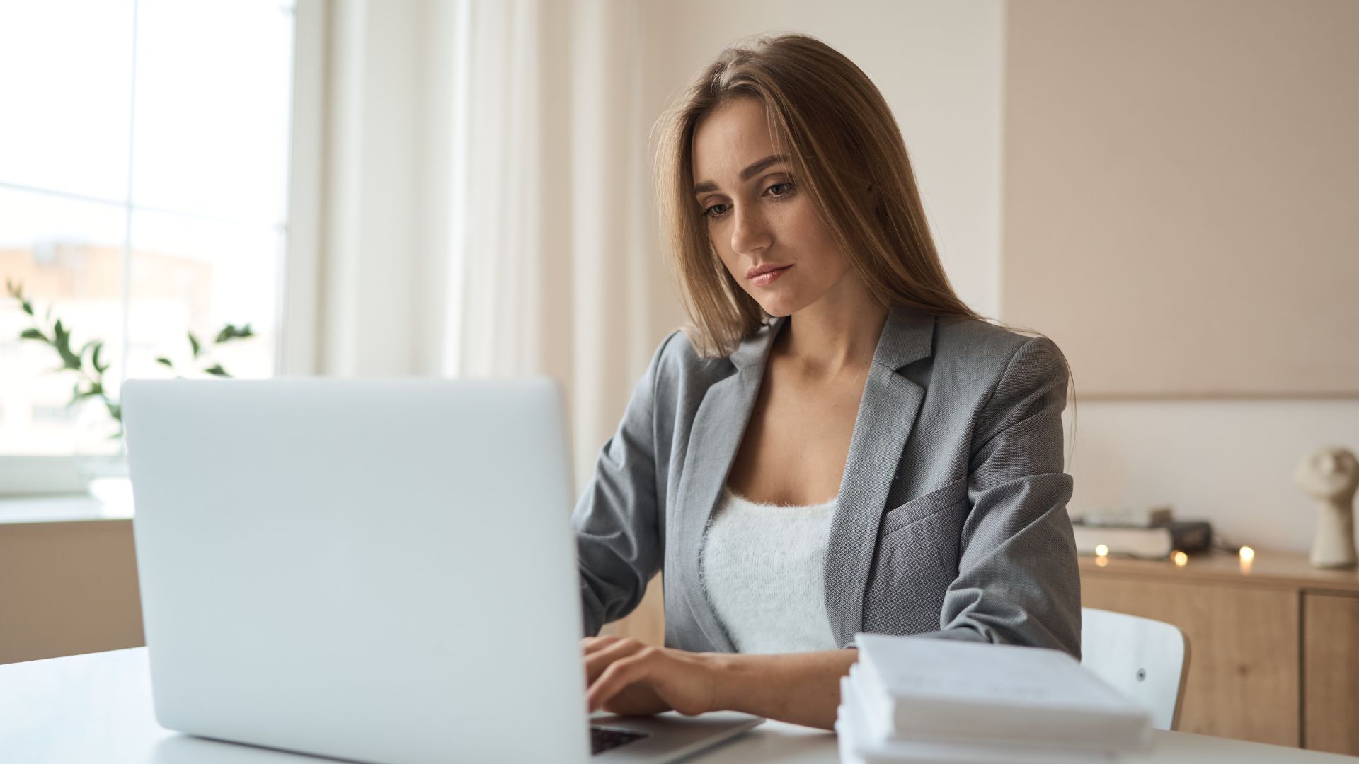 A woman on her laptop researches who exactly needs HACCP Certification.