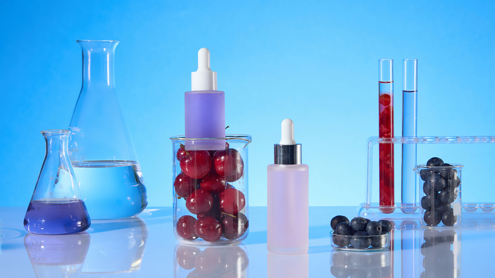 image of cosmetic product in development with beakers, liquids, and ingredients