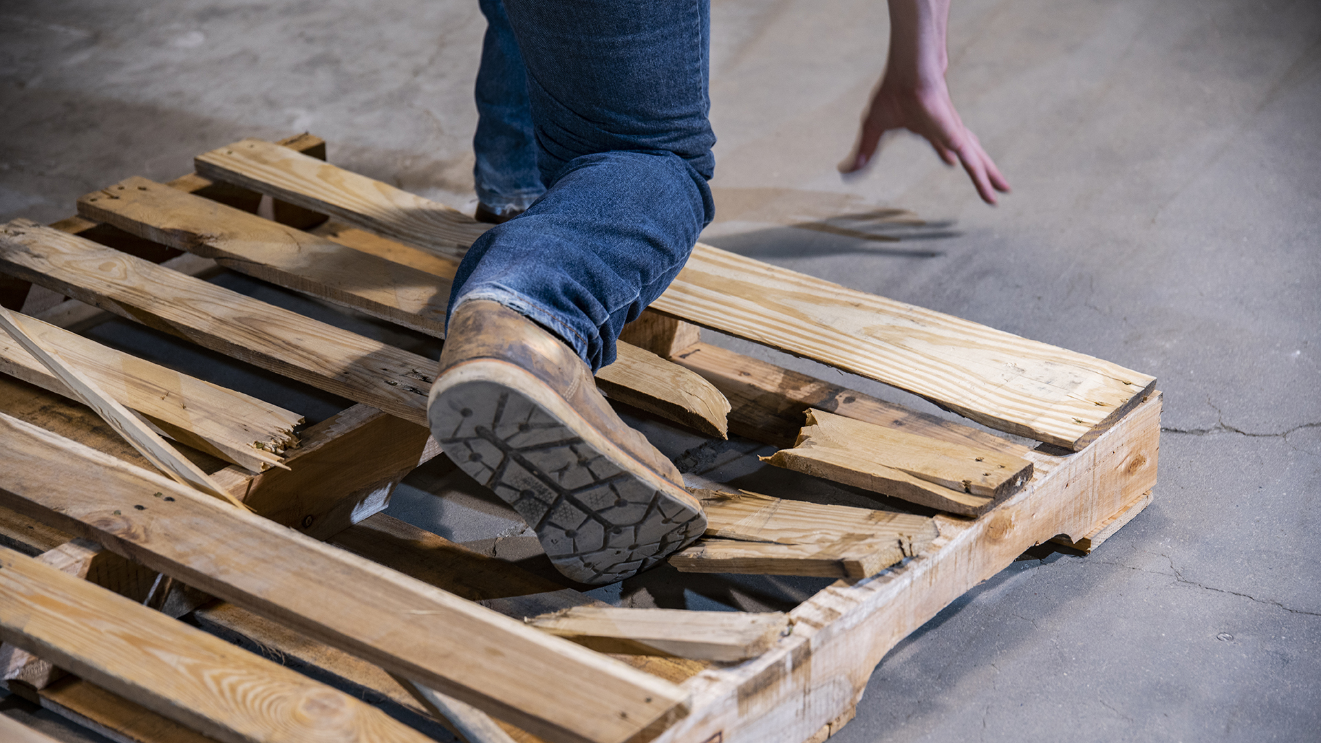 worker tripping over pallet on floor