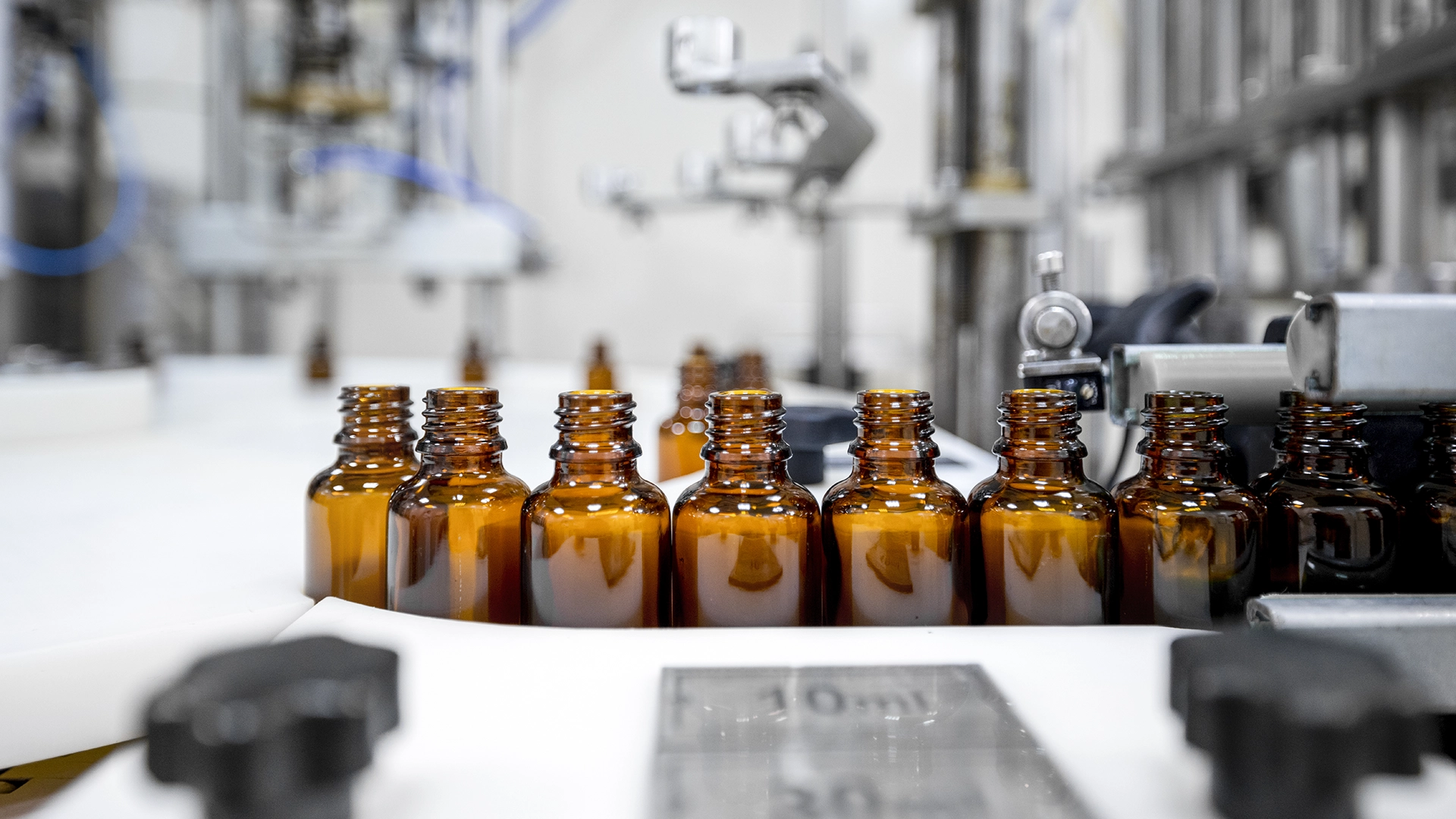 photo showing manufacturing line of essential oils bottles