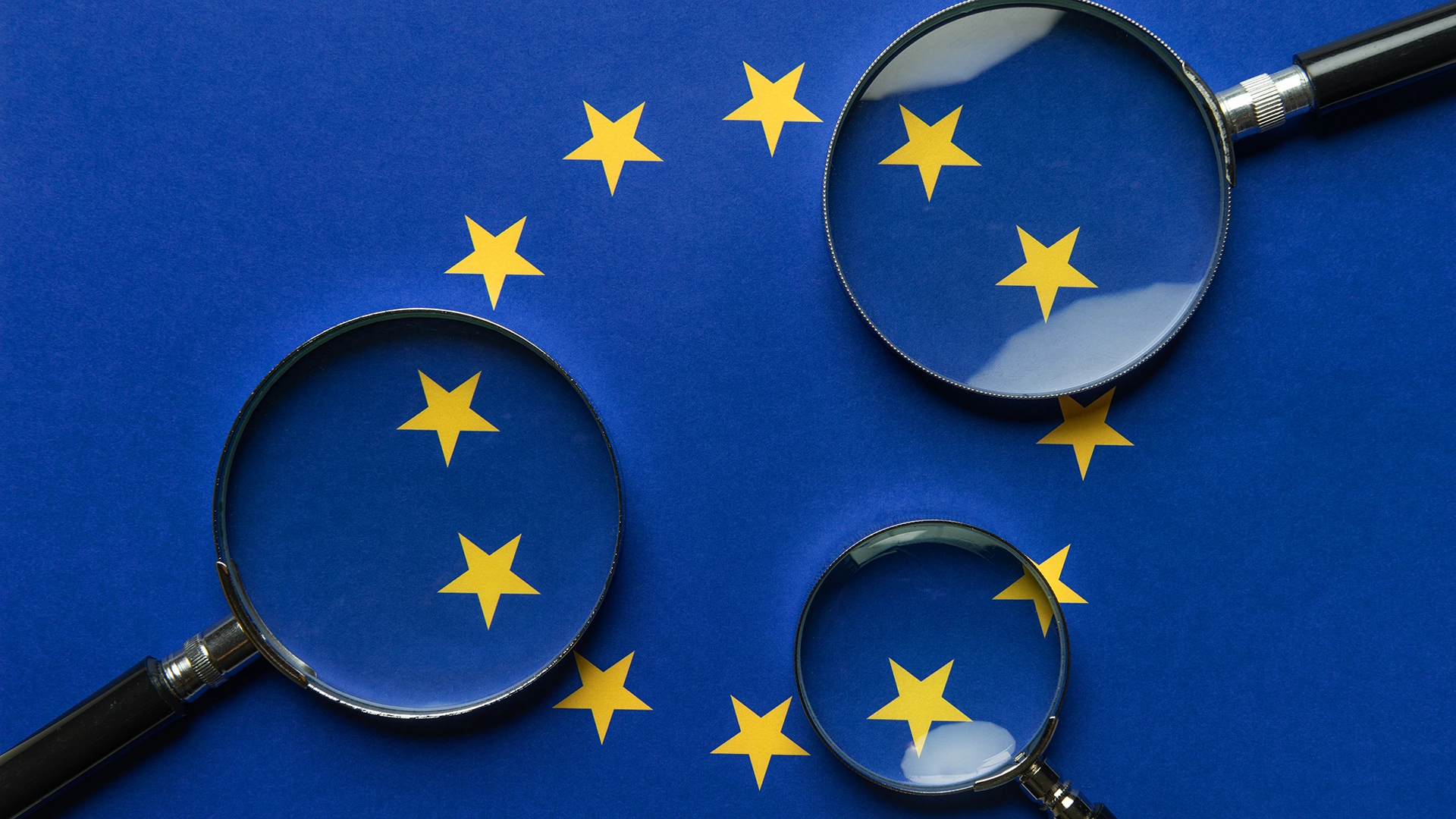 EU flag stars symbol with magnifying glasses inspecting